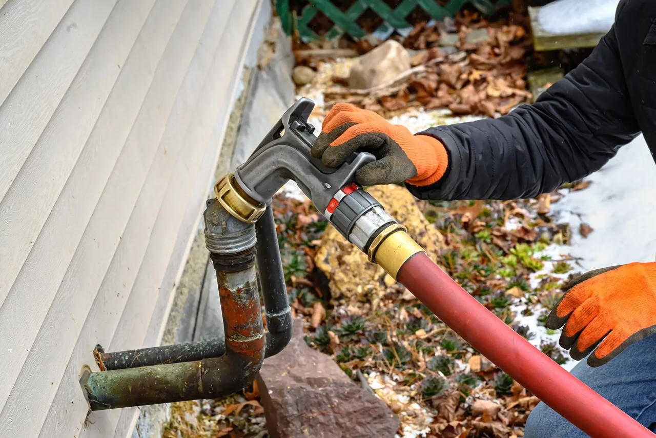 Emergency heating oil delivery truck fueling a home in winter on Long Island